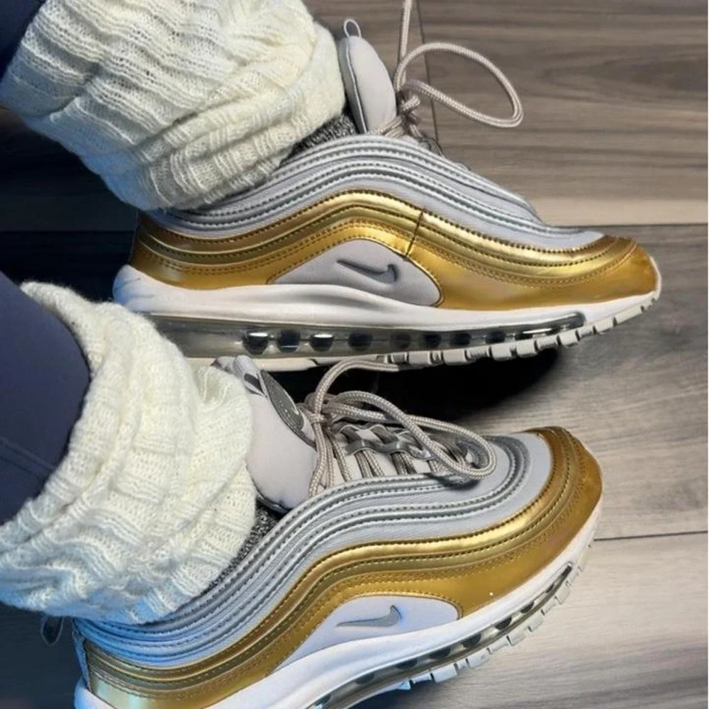 Nike Air Max 97 sneakers in gold and white with silver accents